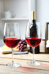 Still life of wine, grape, cheese and bread on light background