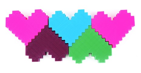 Plastic puzzle hearts isolated on white
