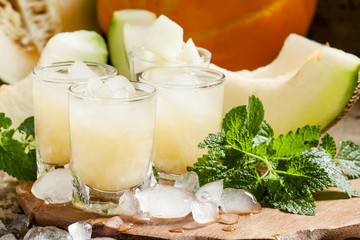 Summer melon refreshing drink with ice and mint, selective focus