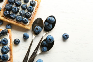 Gourmet fresh blueberry tarts on table