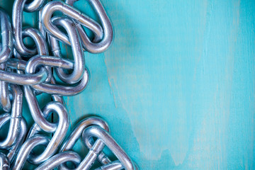 Metal chain on nice wooden background