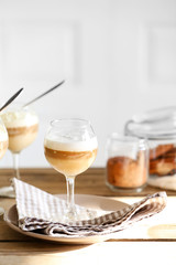 Wine glass with jelly on table, on light background