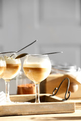 Wine glass with jelly on table, on light background