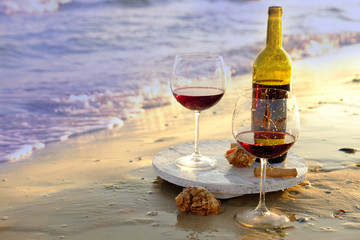 Wine bottle and glasses on the seashore