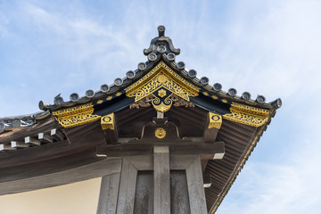 Fototapeta premium Traditional Japanese ornate wooden roof overhang with gold decoration