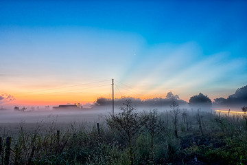 early sunrise over foggy farm landscape in rock hill south carol