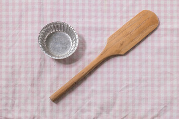 Small paddle and tray for cooking sweet tablecloth background