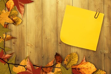 Composite image of  sticky note with grey paperclip