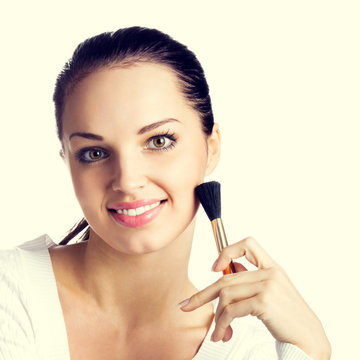 Woman with cosmetics brush