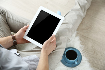 Man working with digital tablet at home