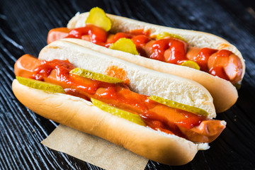 Hot dogs on a black wooden table