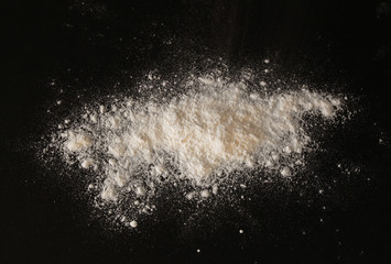 white powder blast over black textured background

