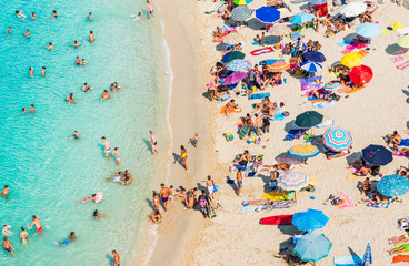 Drone view of Tropea beach, Calabria. Panoramic view of beach with umbrellas top view.