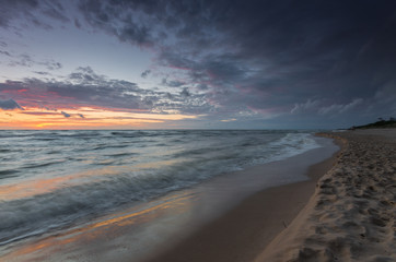 Baltic sea coast at picturesque sunset in Rowy, near Ustka, Poland