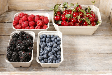 Raspberries, blueberries, blackberries and cherries in carton bo