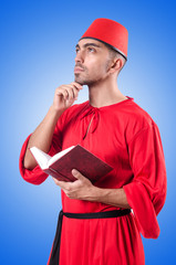 Young turk with book on white