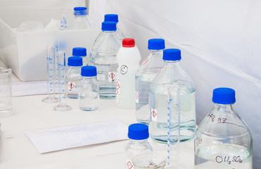 Glass Bottles with Blue Caps with Chemicals