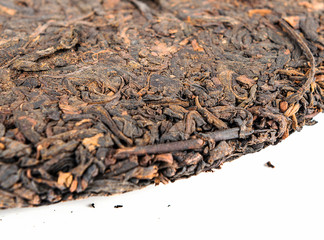 Half of chinese puer tea disc on white background