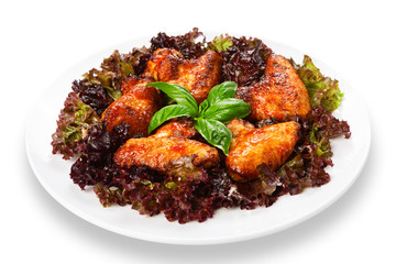 Fried roasted chicken wings on lettuce