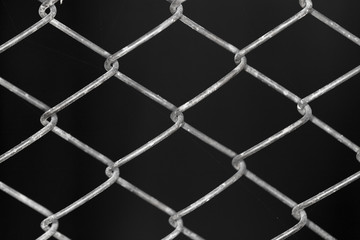 Naklejka premium metal grid on a black background background