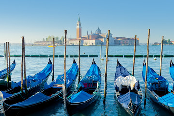 Obraz premium Gondolas moored by Saint Mark square with view Church of San Giorgio Maggiore in the background. Venice, Italy