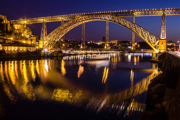 Fototapeta na wymiar San Luis Bridge reflections onto the Douro River, Porto, Portugal