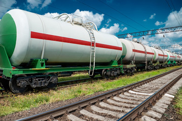 Fototapeta na wymiar White railroad tank cars for oil and gas