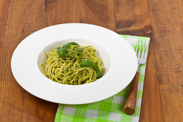 Spaghetti with pesto and basil. Selective focus.