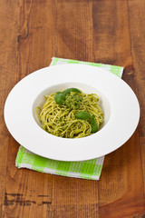 Spaghetti with pesto and basil. Selective focus.