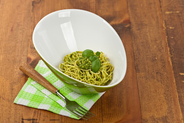 Spaghetti with pesto and basil. Selective focus.