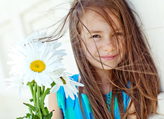 Beautiful girl with camomile bouquet 