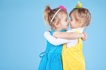 two little sisters in color clothes 