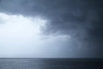 Glasschilderij Hemel Dark dramatic stormy sky over sea
