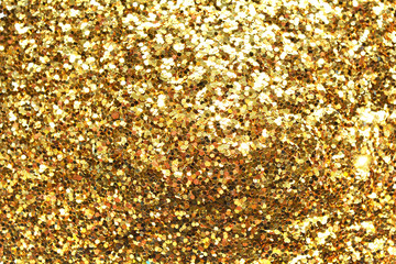 Gold sand and dust texture. Golden sparkling glitter background.