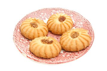 four cookies with jam on a dish