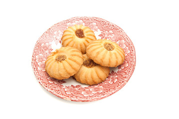 four cookies with jam on a plate