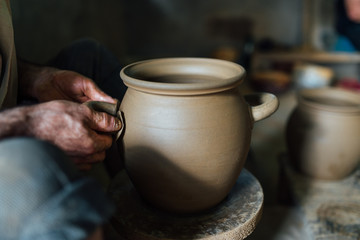 The man make pot from clay