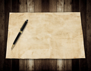 Notepaper and pen on wooden background