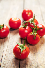 Fresh cherry tomatoes on rustic wooden background