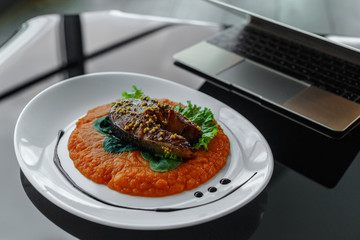Soup in white plate on glance table.