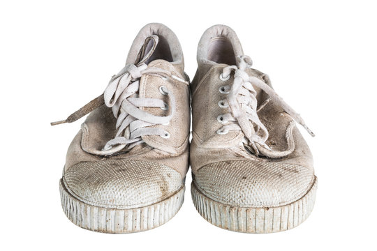 Close up a pair of dirty sneakers isolated on white background.
