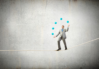Businessman juggling with balls