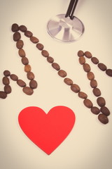 Vintage photo, Cardiogram line of coffee grains, red heart and stethoscope, medicine and healthcare concept