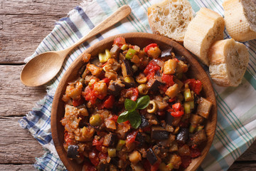 Italian Caponata with aubergines closeup in a plate. horizontal top view
