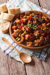 Sicilian cuisine: Caponata with aubergines close-up. Vertical, rustic 
