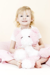 little girl playing with teddy bear