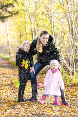 Fototapeta premium mother with her daughters in autumnal nature