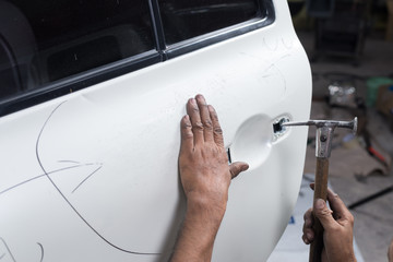 Car paint repair series : Worker repairs white car paint