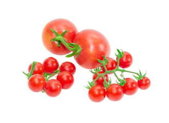 Two branches of cherry tomato and two conventional tomatoes