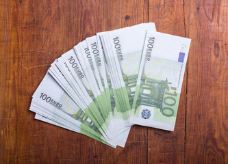 Close-up of  100 Euro banknotes on wood background
